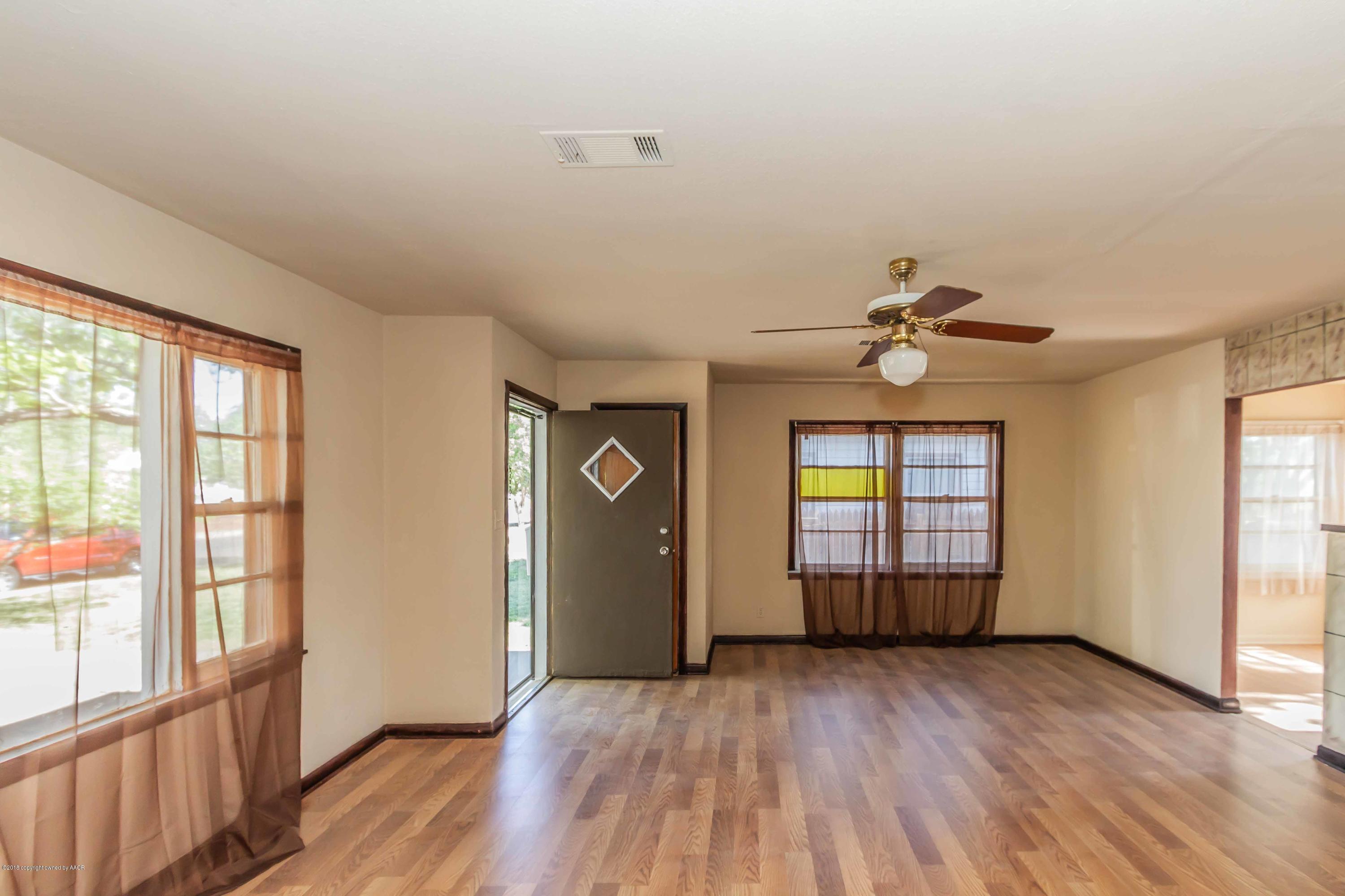 4307 Gables Street Amarillo, TX 79110 - Photo 7 of 32 an empty room with wooden floor and windows