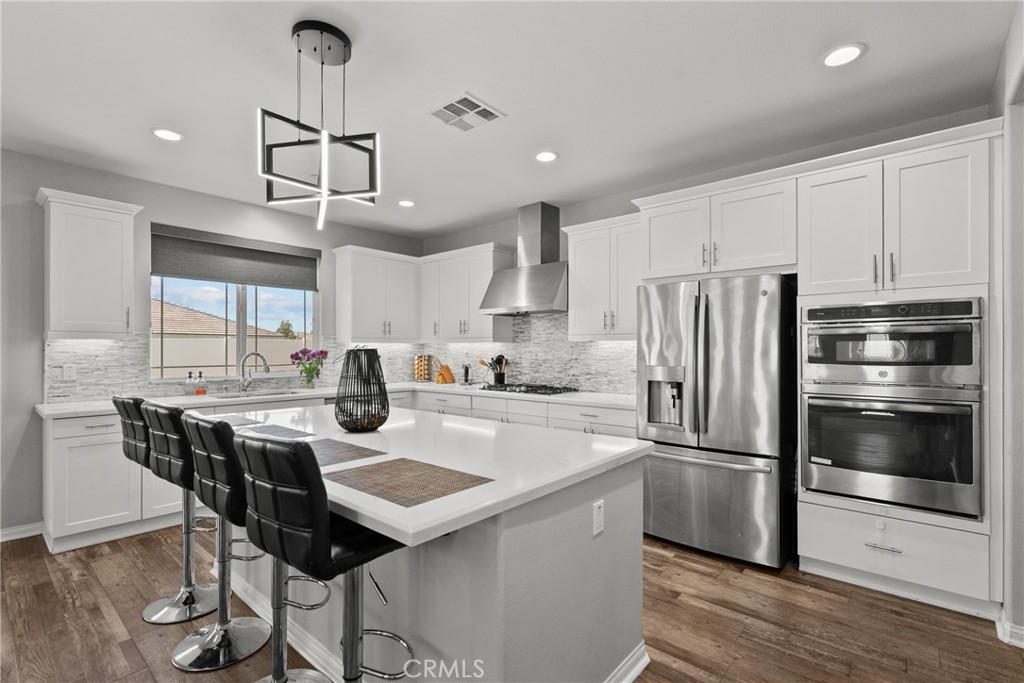 232 River Street Fillmore, CA 93015 - Photo 15 of 61 a kitchen with stainless steel appliances a table chairs refrigerator and cabinets