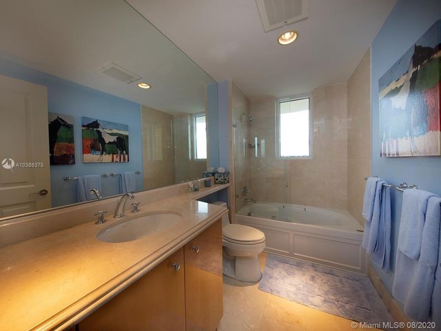 a bathroom with a sink a toilet and bathtub