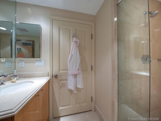 a bathroom with a shower sink and mirror