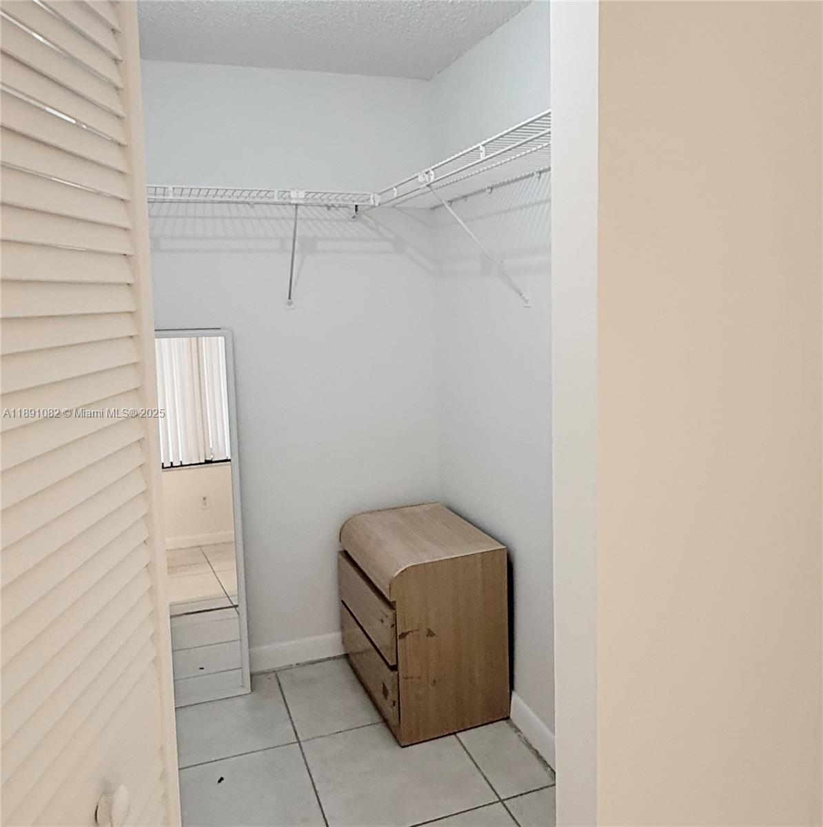 8275 Southwest 152nd Avenue, Unit D408 Miami, FL 33193 - Photo 5 of 9 a room with a bench