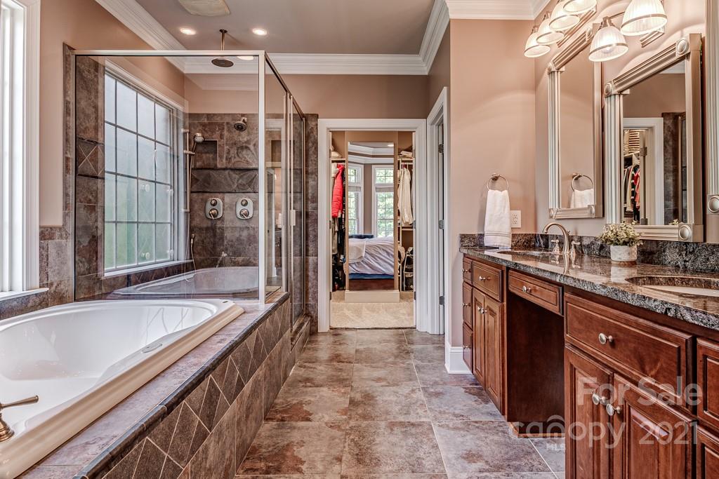 150 Canterbury Crossing Fort Mill, SC 29708 - Photo 19 of 48 a bathroom with a tub a sink and a large mirror