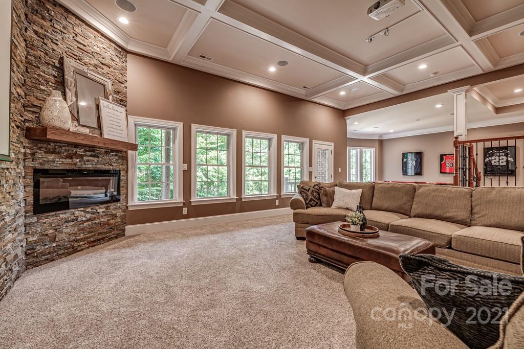 150 Canterbury Crossing Fort Mill, SC 29708 - Photo 23 of 48 a living room with furniture a flat screen tv and a fireplace