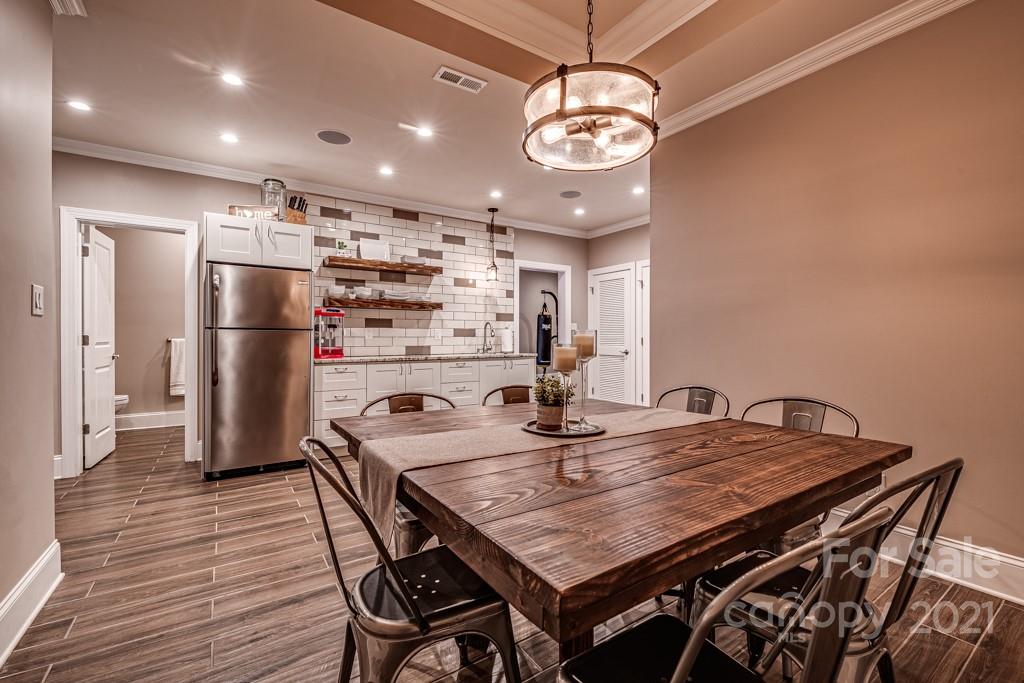 150 Canterbury Crossing Fort Mill, SC 29708 - Photo 26 of 48 a kitchen with stainless steel appliances granite countertop a table chairs and refrigerator