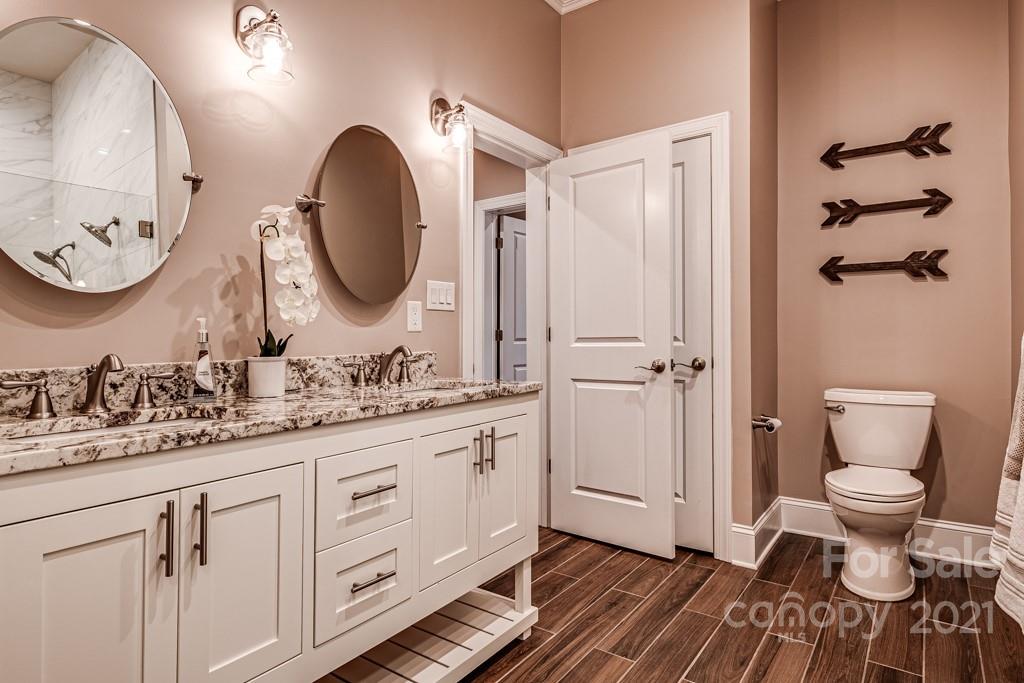 150 Canterbury Crossing Fort Mill, SC 29708 - Photo 28 of 48 a bathroom with a granite countertop toilet a sink and a mirror