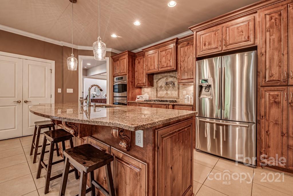 150 Canterbury Crossing Fort Mill, SC 29708 - Photo 6 of 48 a kitchen with stainless steel appliances granite countertop a refrigerator a sink and a stove