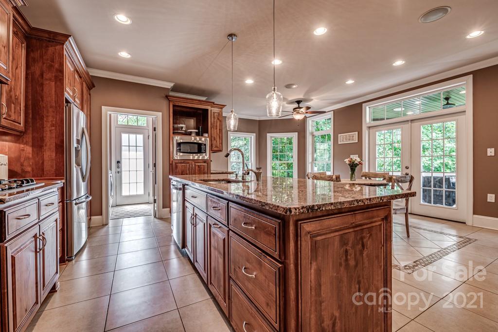 150 Canterbury Crossing Fort Mill, SC 29708 - Photo 8 of 48 a kitchen with stainless steel appliances granite countertop a stove and cabinets