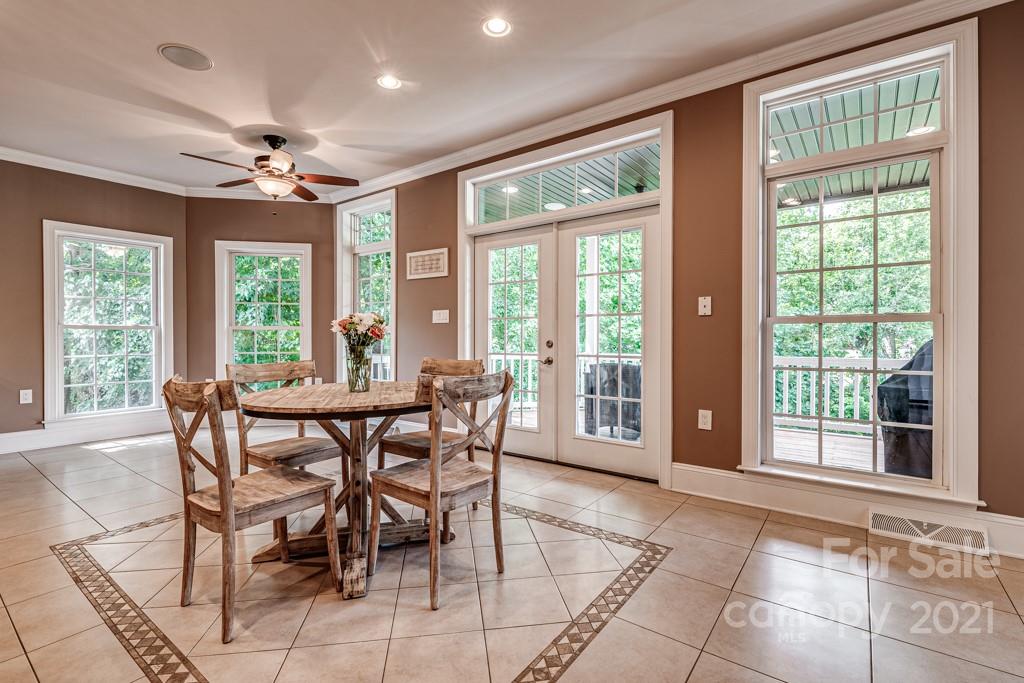 150 Canterbury Crossing Fort Mill, SC 29708 - Photo 9 of 48 a view of a dining room with furniture large windows and wooden floor