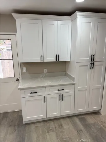 a view of white cabinets and window