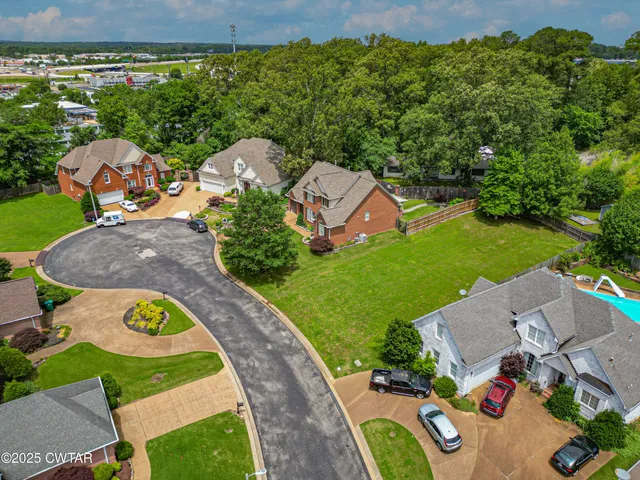 an aerial view of a house with garden space and street view