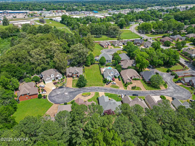 an aerial view of a house with swimming pool outdoor seating and yard