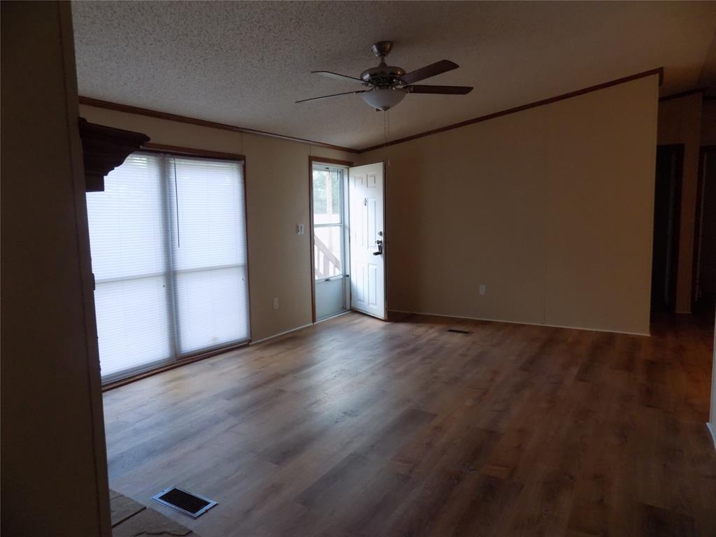 3450 Sarra Lane Springtown, TX 76082 - Photo 5 of 23 Open living room from the front door into the light and bright room.