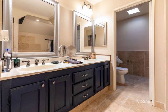 420 Montefino Drive Ridgecrest, CA 93555 - Photo 21 of 38 a bathroom with a double vanity sink mirror and toilet
