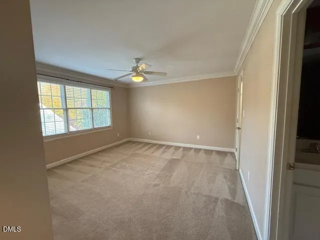 an empty room with window and hardwood floor