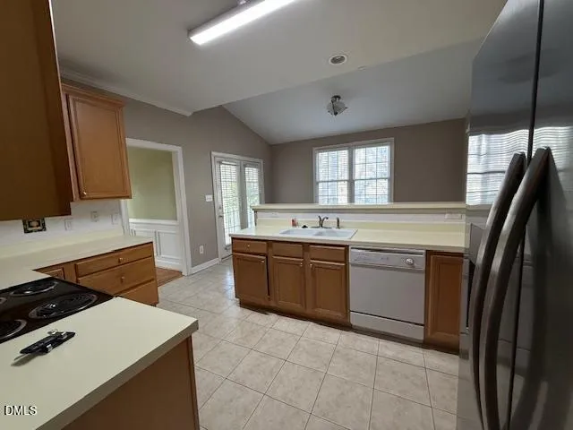 a kitchen with a stove a sink and a refrigerator
