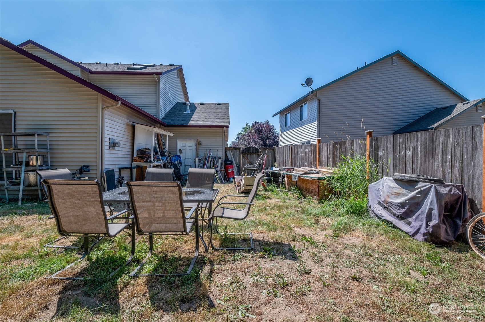 403 Rohrer Loop Sedro-Woolley, WA 98284 - Photo 20 of 24 a view of a backyard with table and chairs potted plants and wooden fence