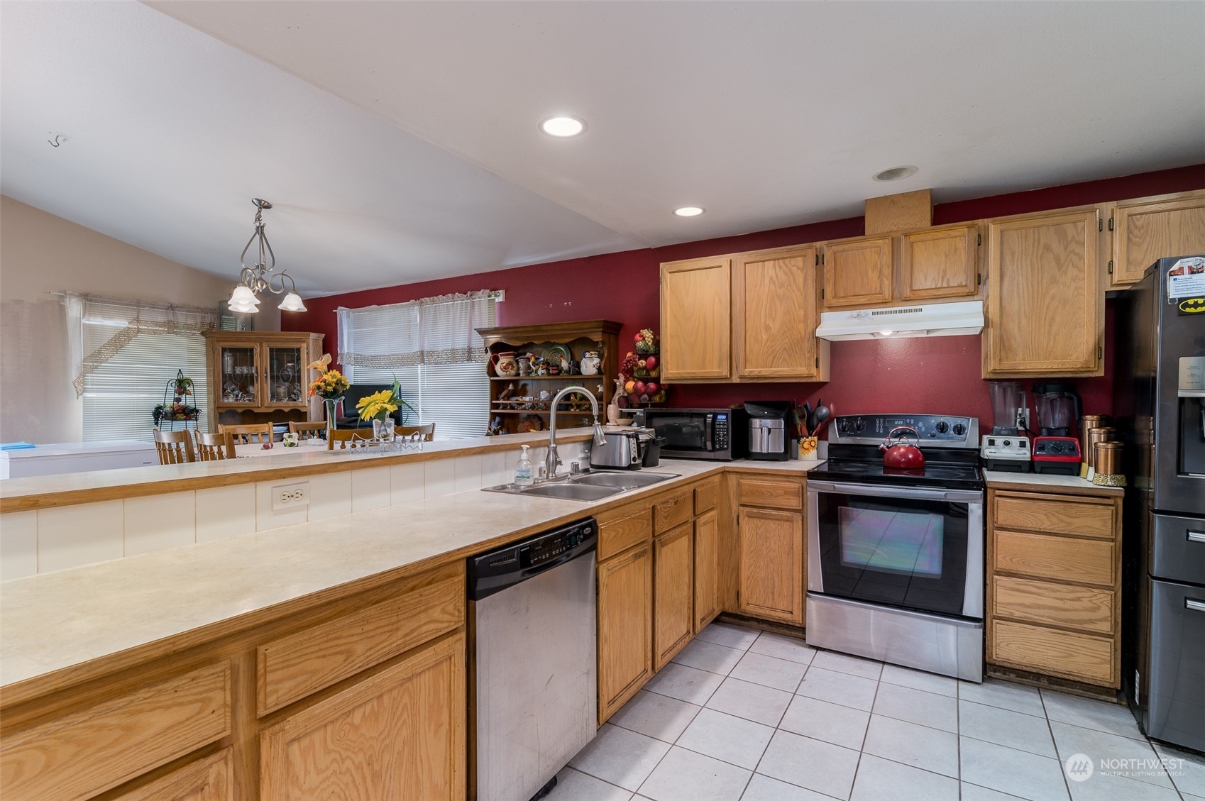 403 Rohrer Loop Sedro-Woolley, WA 98284 - Photo 3 of 24 a kitchen with stainless steel appliances granite countertop a sink counter space cabinets and a refrigerator
