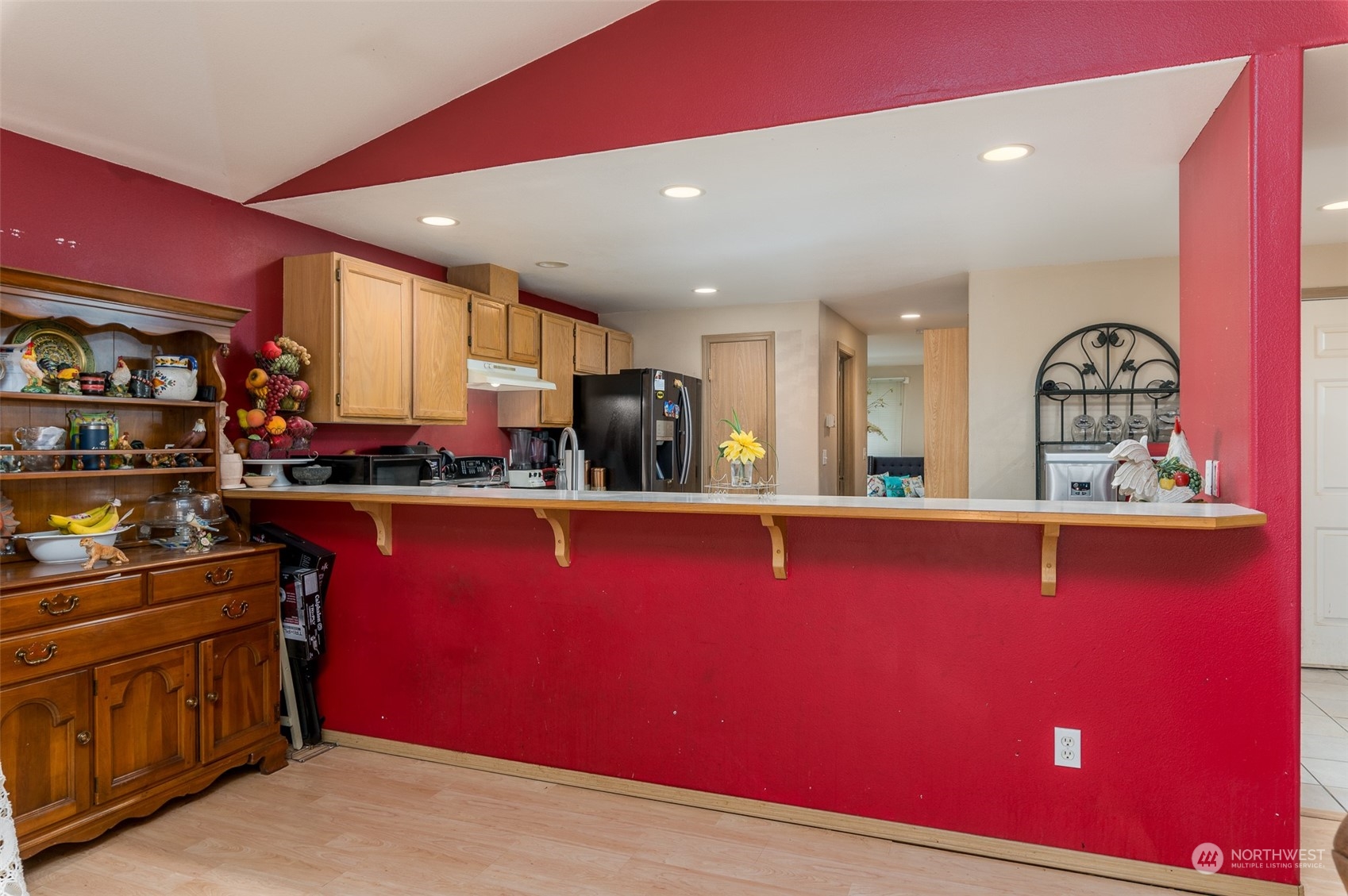 403 Rohrer Loop Sedro-Woolley, WA 98284 - Photo 4 of 24 a kitchen with stainless steel appliances kitchen island granite countertop a red stove top oven a sink with wooden cabinets and dining table