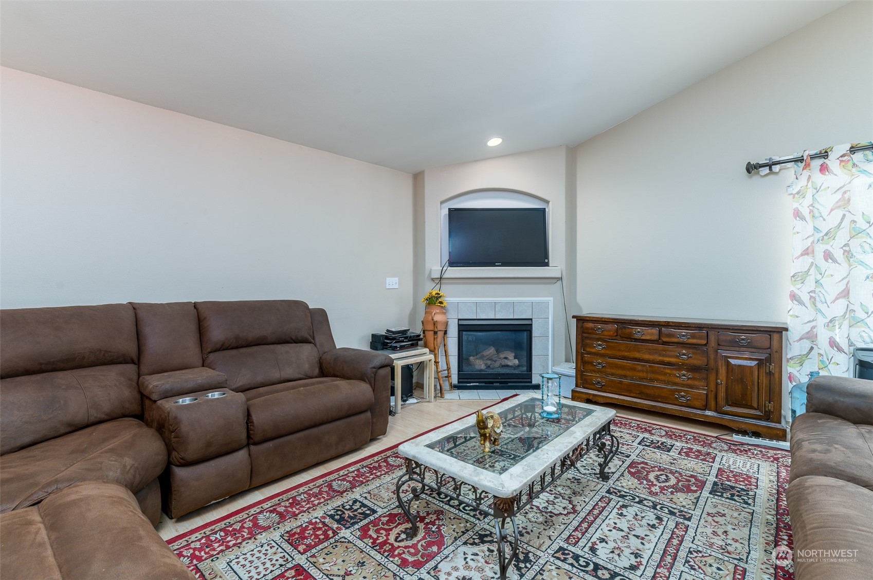 403 Rohrer Loop Sedro-Woolley, WA 98284 - Photo 7 of 24 a living room with furniture a fireplace and a flat screen tv