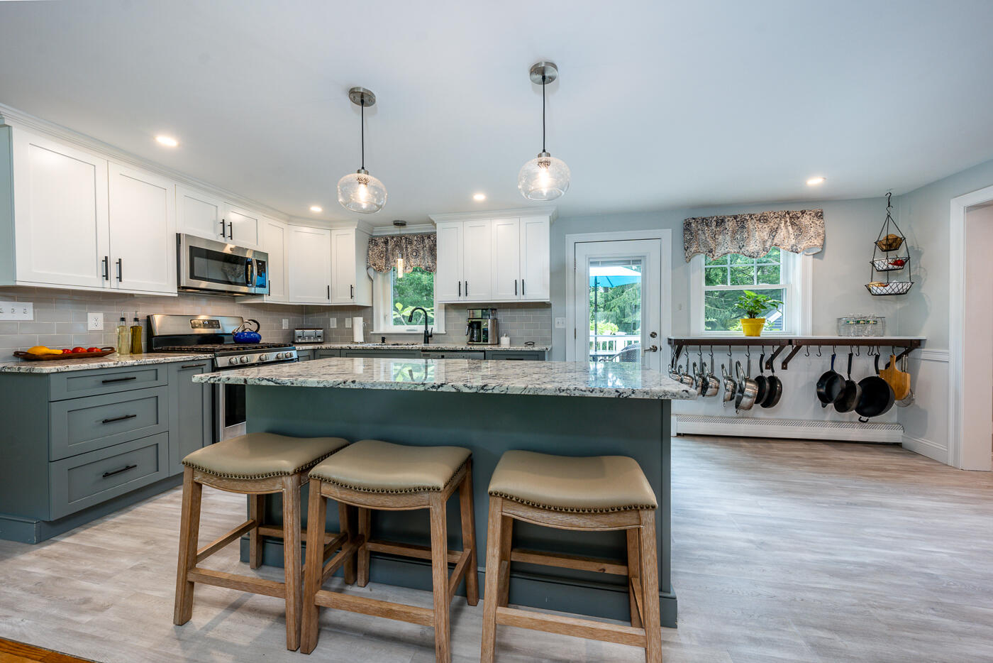 157 Lumbert Mill Road Centerville, MA 02632 - Photo 11 of 42 a kitchen with granite countertop a stove a sink a window and chairs