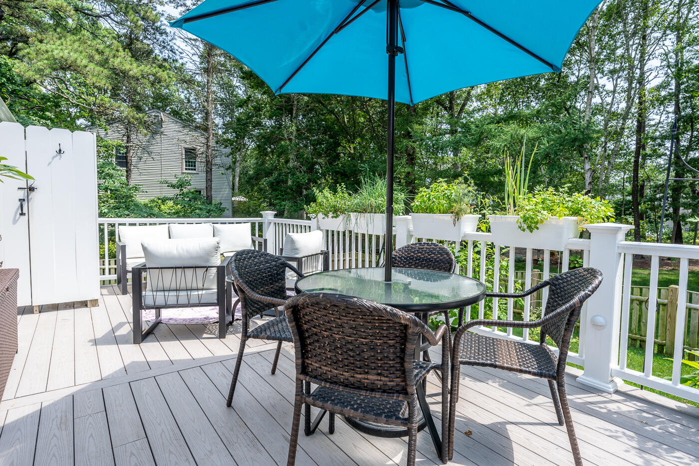 157 Lumbert Mill Road Centerville, MA 02632 - Photo 30 of 42 a view of an outdoor sitting area with furniture and umbrella