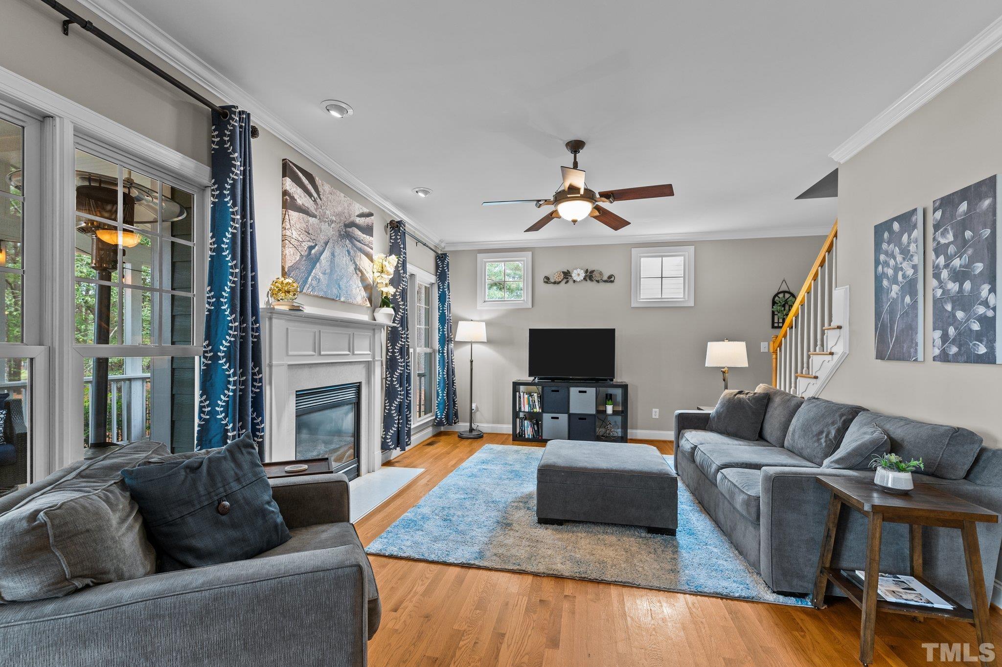 1209 Colonial Club Road Wake Forest, NC 27587 - Photo 12 of 28 a living room with furniture a fireplace and a flat screen tv