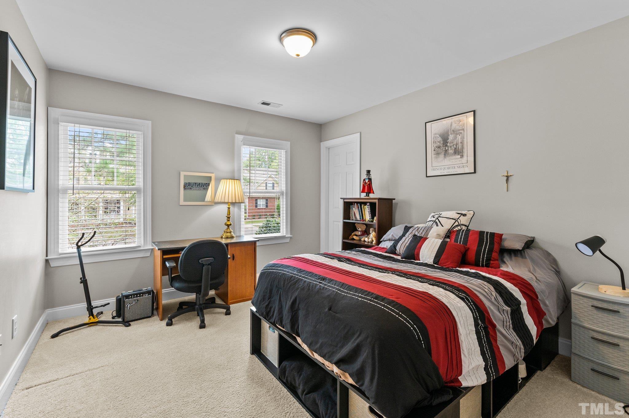 1209 Colonial Club Road Wake Forest, NC 27587 - Photo 13 of 28 a bed room with a bed and a desk
