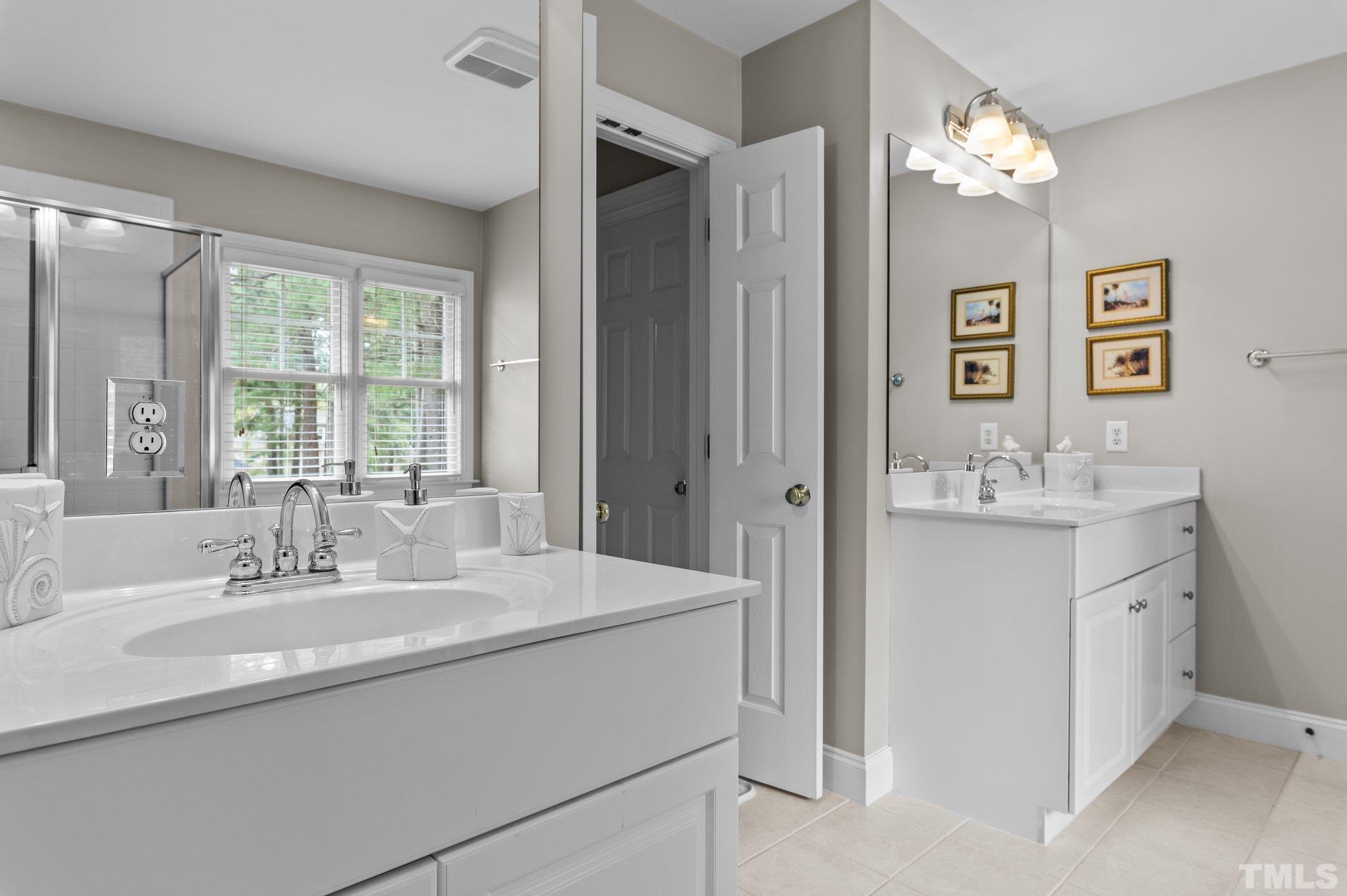 1209 Colonial Club Road Wake Forest, NC 27587 - Photo 17 of 28 a bathroom with a sink double vanity and a mirror