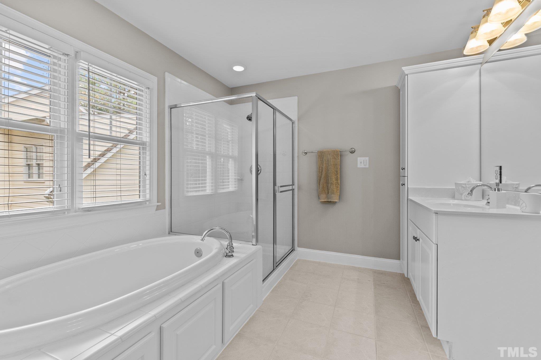 1209 Colonial Club Road Wake Forest, NC 27587 - Photo 18 of 28 a spacious bathroom with a tub shower and sink