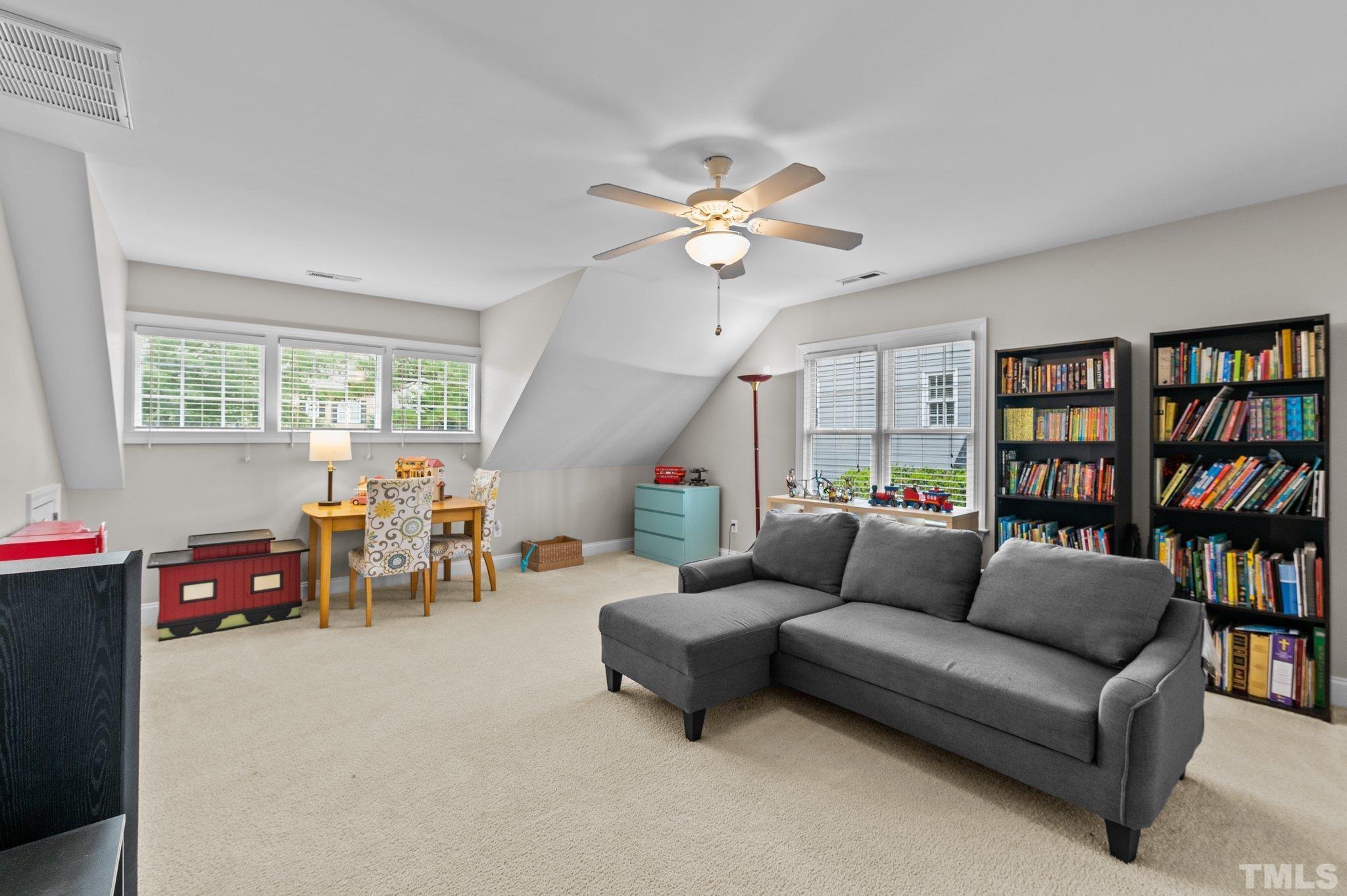 1209 Colonial Club Road Wake Forest, NC 27587 - Photo 19 of 28 a living room with furniture and a book shelf