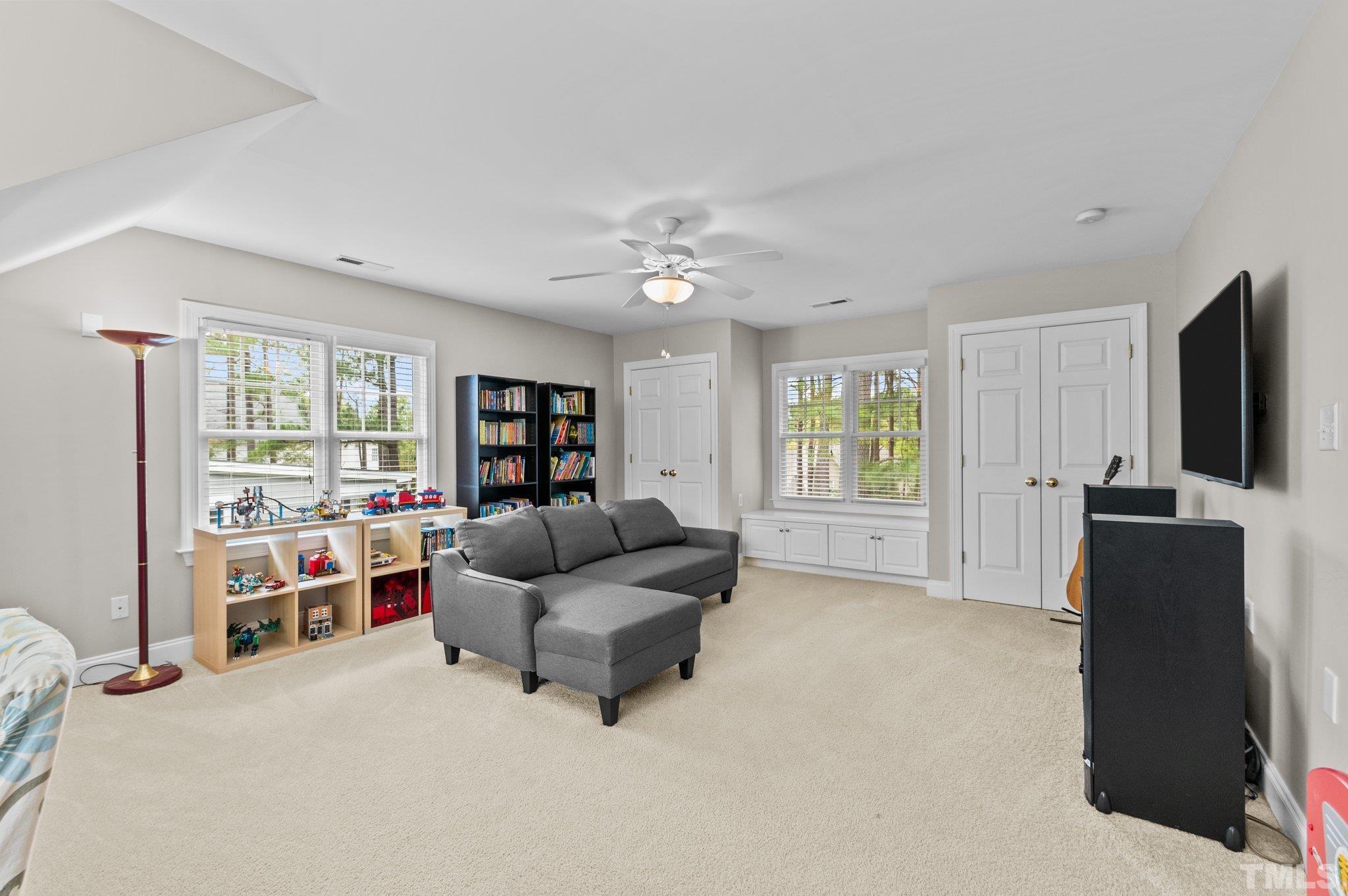 1209 Colonial Club Road Wake Forest, NC 27587 - Photo 20 of 28 a living room with furniture and a flat screen tv