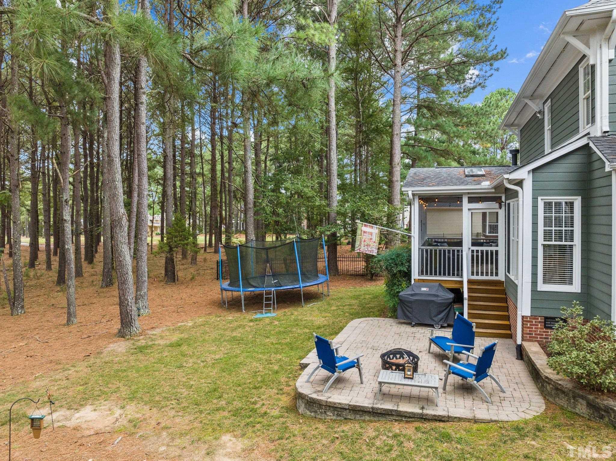 1209 Colonial Club Road Wake Forest, NC 27587 - Photo 21 of 28 a view of a house with backyard swimming pool and sitting area