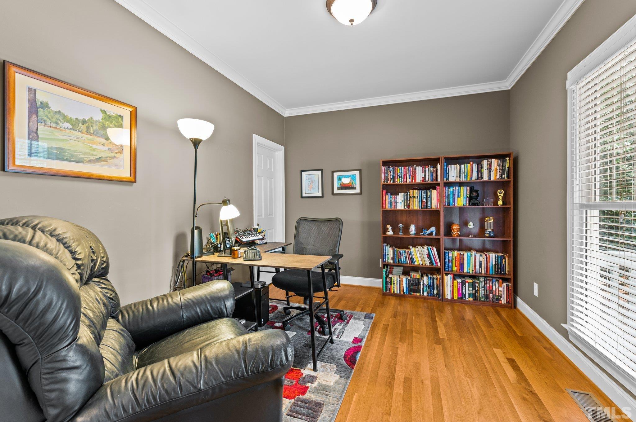 1209 Colonial Club Road Wake Forest, NC 27587 - Photo 6 of 28 a living room with furniture and a wooden floor