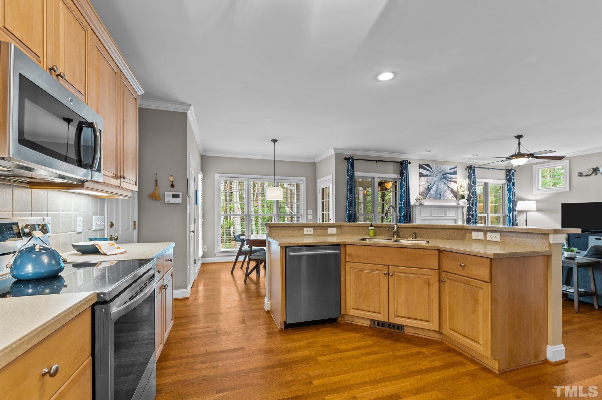 1209 Colonial Club Road Wake Forest, NC 27587 - Photo 7 of 28 a kitchen with stainless steel appliances granite countertop a stove and cabinets