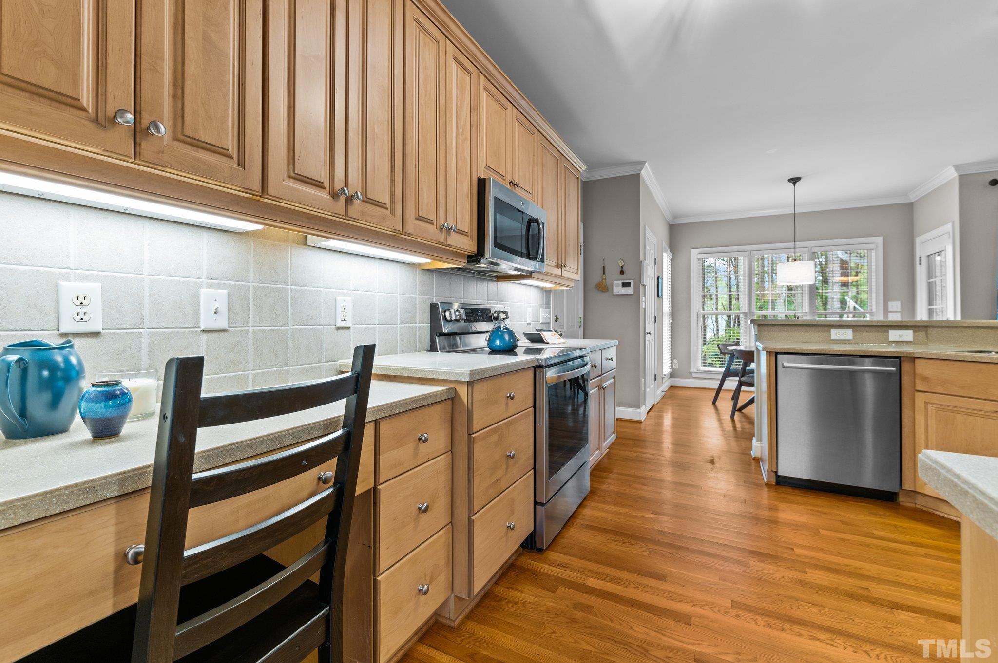 1209 Colonial Club Road Wake Forest, NC 27587 - Photo 8 of 28 a kitchen with stainless steel appliances sink microwave and cabinets
