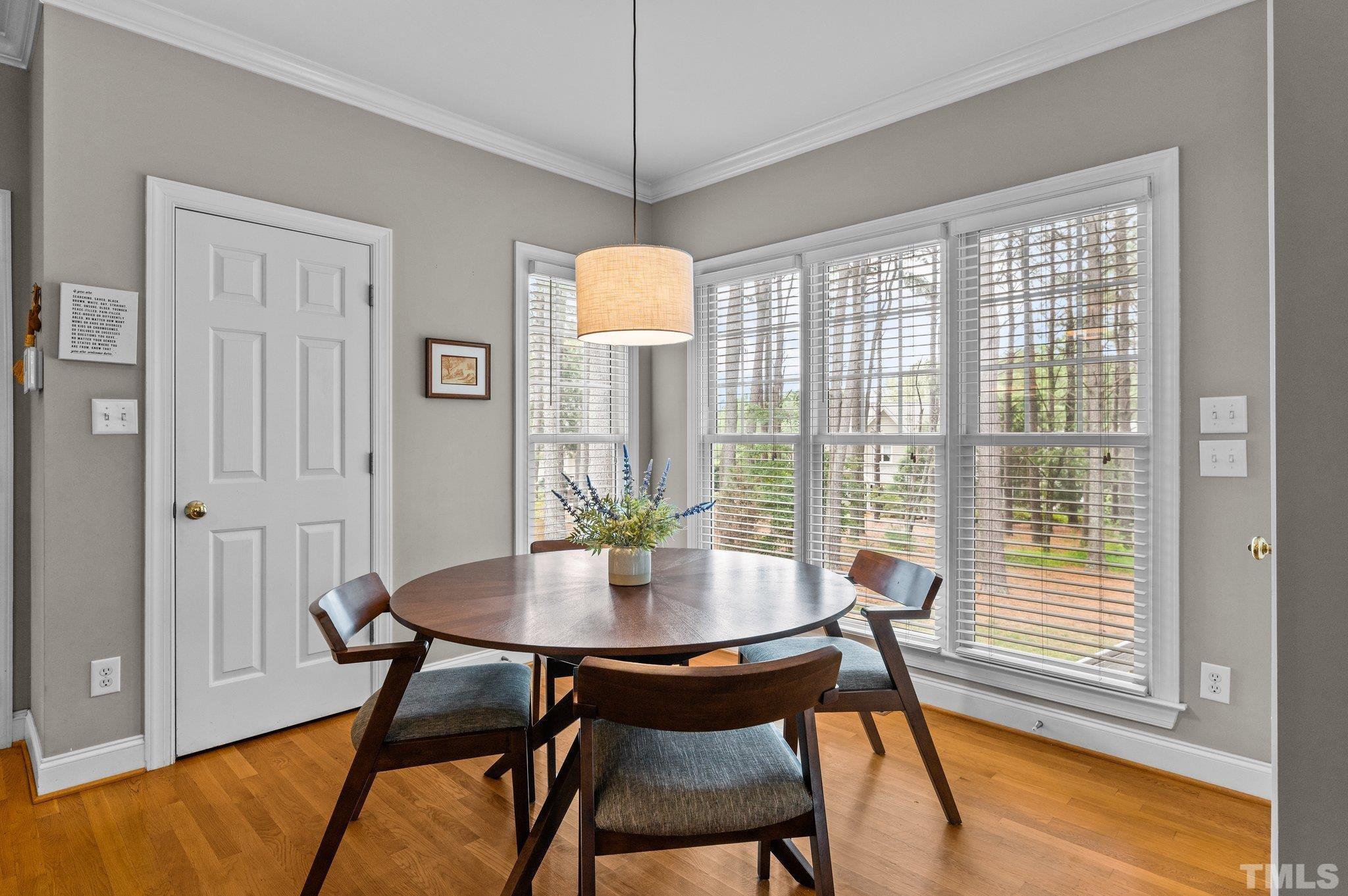 1209 Colonial Club Road Wake Forest, NC 27587 - Photo 10 of 28 a view of a dining room with furniture window and wooden floor