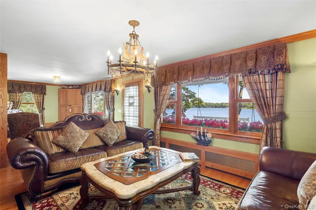 a living room with furniture and a chandelier