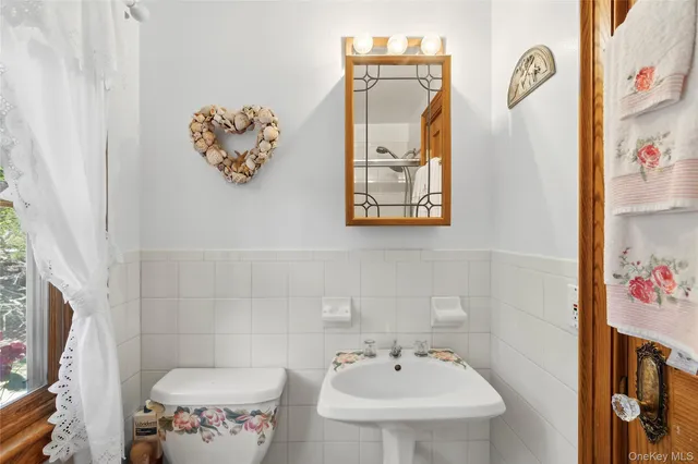 a bathroom with a sink mirror and vanity