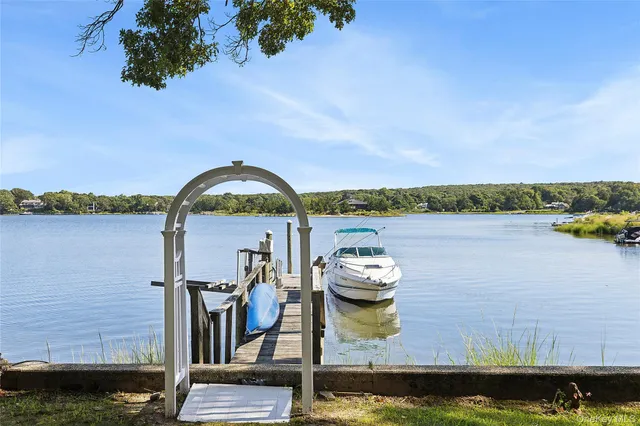 a view of a lake with sitting area and a lake view