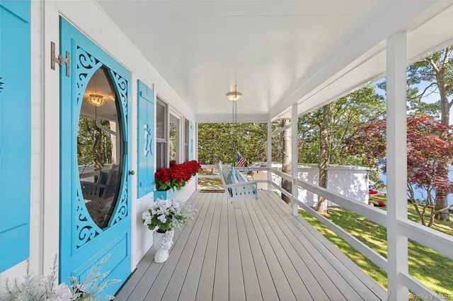 a living room with large windows and wooden floor