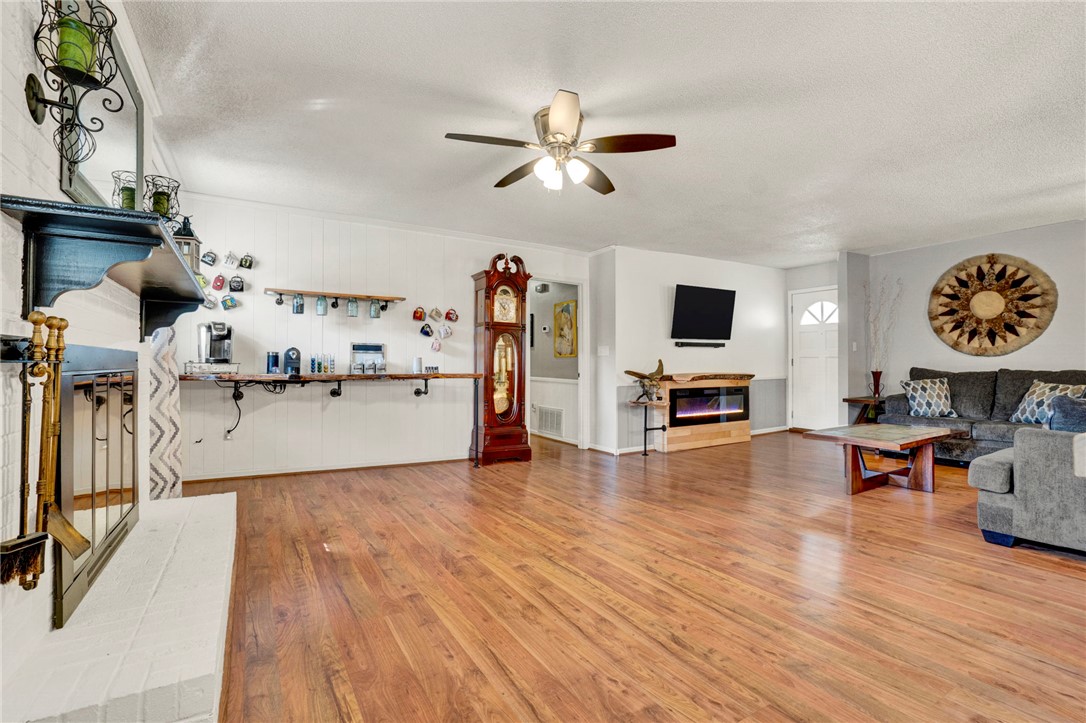 133 Old Liberty Pickens Road Pickens, SC 29671 - Photo 11 of 48 This expansive living area features warm wood flooring and a charming fireplace, perfect for gatherings.