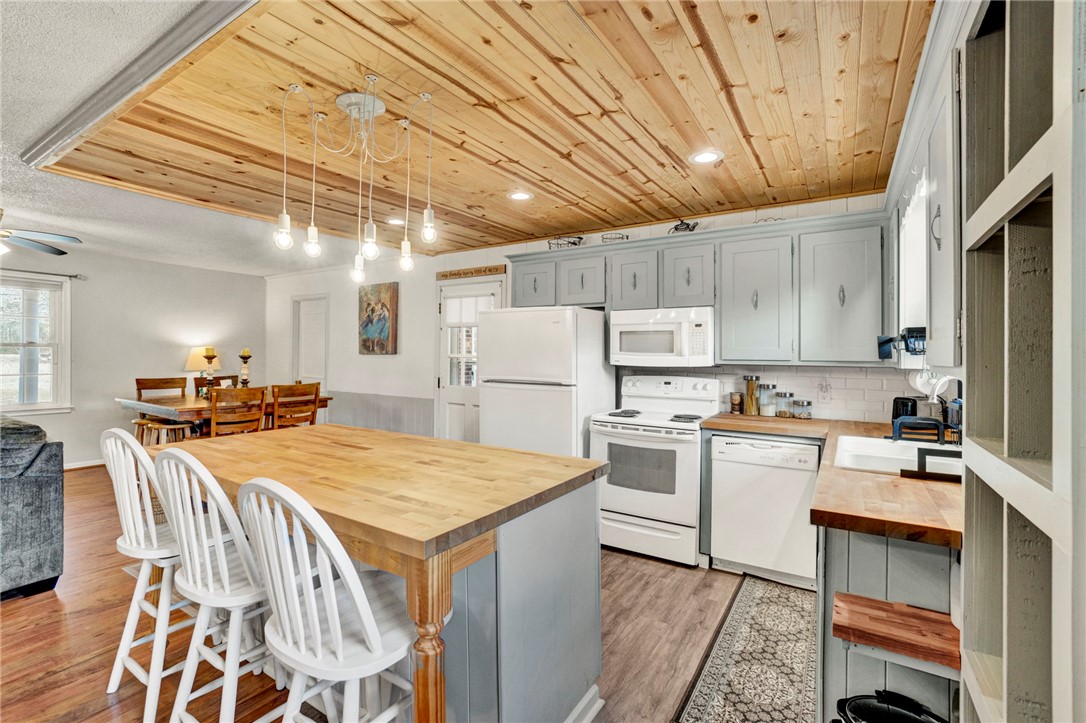 133 Old Liberty Pickens Road Pickens, SC 29671 - Photo 12 of 48 This inviting kitchen and dining area features a unique wooden ceiling and functional island.