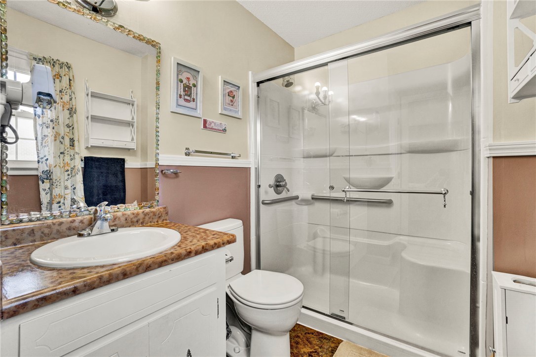 133 Old Liberty Pickens Road Pickens, SC 29671 - Photo 24 of 48 A well-appointed bathroom features a practical vanity and a glass-enclosed shower.