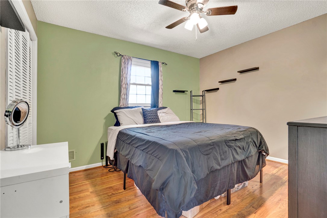 133 Old Liberty Pickens Road Pickens, SC 29671 - Photo 25 of 48 This cozy bedroom features warm wood flooring and a refreshing ceiling fan for comfort.