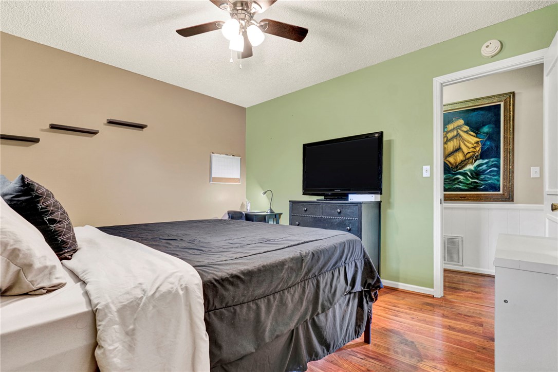133 Old Liberty Pickens Road Pickens, SC 29671 - Photo 26 of 48 This cozy bedroom features warm wood flooring and a refreshing ceiling fan for comfort.