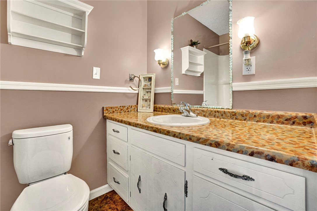 133 Old Liberty Pickens Road Pickens, SC 29671 - Photo 29 of 48 This clean and functional bathroom features a single vanity, a toilet, and a combination shower/tub.