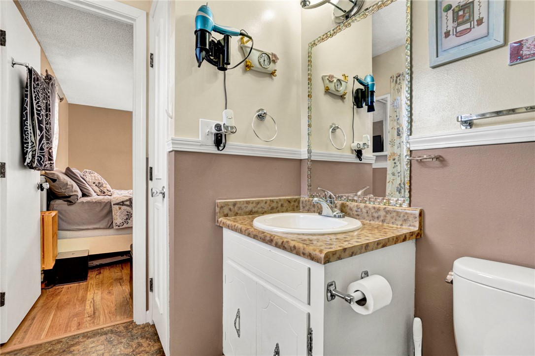133 Old Liberty Pickens Road Pickens, SC 29671 - Photo 31 of 48 This functional bathroom features a classic vanity and convenient toilet, with an adjoining bedroom.