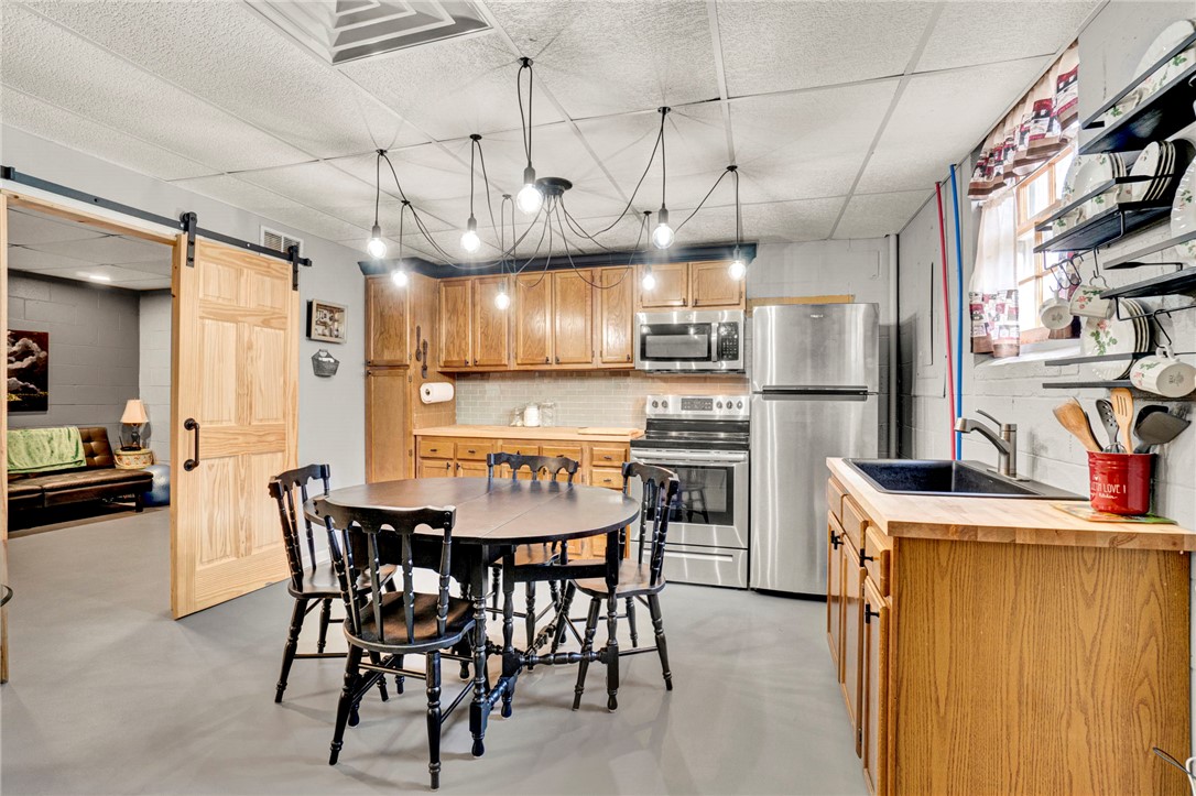 133 Old Liberty Pickens Road Pickens, SC 29671 - Photo 35 of 48 This kitchen offers warm wood cabinetry and stainless steel appliances, creating a functional and inviting space.