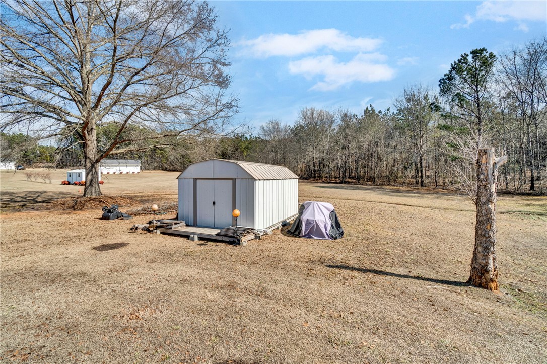 133 Old Liberty Pickens Road Pickens, SC 29671 - Photo 47 of 48 This expansive yard features a storage shed and mature trees, offering ample outdoor space.