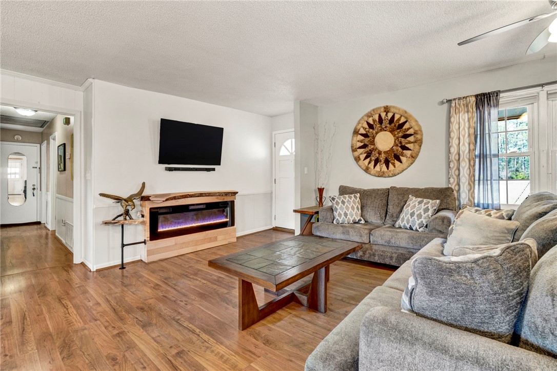 133 Old Liberty Pickens Road Pickens, SC 29671 - Photo 7 of 48 This living area features a warm fireplace and rich wood flooring, ideal for gatherings.